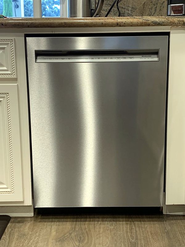 Dishwasher installation between white cabinets